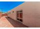 Wide shot of the brick and concrete backyard patio with sliding glass doors at 5314 N Las Casitas Pl, Phoenix, AZ 85016
