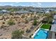 A bird's eye perspective showcases a backyard pool and open desert space in an established community at 5724 E Scarlet St, Mesa, AZ 85215