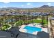 Aerial view of the community pool, common areas, and homes surrounded by palm trees and green landscaping at 5724 E Scarlet St, Mesa, AZ 85215