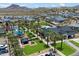 Aerial view of community amenities including pool, playground, and basketball court, with homes and mountain views at 5724 E Scarlet St, Mesa, AZ 85215
