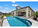 Expansive backyard featuring a pristine pool, covered patio, and well-maintained artificial grass area at 5724 E Scarlet St, Mesa, AZ 85215