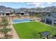 Community basketball court and green space surrounded by homes and walking path with lush landscaping at 5724 E Scarlet St, Mesa, AZ 85215