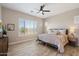 Comfortable bedroom featuring a neutral color palette, wood-look floors, and a window with plantation shutters at 5724 E Scarlet St, Mesa, AZ 85215