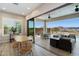 Bright dining area with light wood floors and open access to a covered patio and outdoor pool area at 5724 E Scarlet St, Mesa, AZ 85215