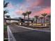 A daytime shot of the community entrance and signage lined with palm trees at 5724 E Scarlet St, Mesa, AZ 85215