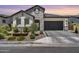 Charming single-Gathering home with stone accents, three-car garage, and manicured landscaping at 5724 E Scarlet St, Mesa, AZ 85215