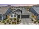 Charming single-Gathering home featuring stone accents, a two-car garage, and professionally landscaped front yard at 5724 E Scarlet St, Mesa, AZ 85215