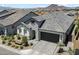 Beautiful home with a stone facade, a paved driveway, desert landscaping, and an attached two-car garage at 5724 E Scarlet St, Mesa, AZ 85215