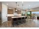 Spacious kitchen with a large island, pendant lighting, stainless steel appliances, and seamless flow to dining area at 5724 E Scarlet St, Mesa, AZ 85215
