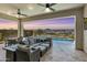Relaxing covered patio featuring a ceiling fan, outdoor seating, and a beautiful view of the pool at 5724 E Scarlet St, Mesa, AZ 85215