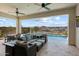 Relaxing covered patio overlooking a sparkling pool and lush landscaping with distant neighborhood views at 5724 E Scarlet St, Mesa, AZ 85215