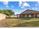 Expansive backyard featuring a covered patio and well-maintained lawn at 635 S Lanus Dr, Gilbert, AZ 85296