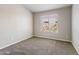 Cozy bedroom with neutral carpet and a bright window offering natural light at 635 S Lanus Dr, Gilbert, AZ 85296