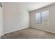 Cozy bedroom with neutral carpeting and a large window providing natural light at 635 S Lanus Dr, Gilbert, AZ 85296