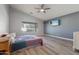 Spacious main bedroom featuring vaulted ceilings, wood floors, and a ceiling fan at 635 S Lanus Dr, Gilbert, AZ 85296