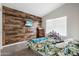 Bedroom with wood accent wall, window with blinds, and closet for storage, and a bed at 635 S Lanus Dr, Gilbert, AZ 85296