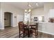 Cozy dining area adjacent to the kitchen, featuring a chandelier and a view of the living space at 635 S Lanus Dr, Gilbert, AZ 85296