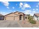 Charming single-story home boasts a three-car garage and landscaped front yard at 635 S Lanus Dr, Gilbert, AZ 85296
