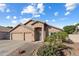 Attractive single-story home with a three-car garage, desert landscaping, and a neatly maintained yard at 635 S Lanus Dr, Gilbert, AZ 85296