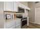 Well-equipped kitchen features stainless steel appliances, white cabinetry and stone countertops at 635 S Lanus Dr, Gilbert, AZ 85296