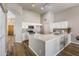 Open kitchen with stainless appliances, quartz countertops, hardwood floors and white cabinets at 635 S Lanus Dr, Gilbert, AZ 85296