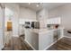 Modern kitchen with white cabinets, quartz countertops and stainless steel appliances, next to entryway at 635 S Lanus Dr, Gilbert, AZ 85296