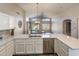 Open kitchen overlooks living area, with stainless appliances and quartz countertops at 635 S Lanus Dr, Gilbert, AZ 85296