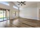 Bright living room with vaulted ceilings, wood floors, and sliding glass doors to the backyard at 635 S Lanus Dr, Gilbert, AZ 85296