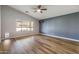 Inviting living area boasting wood floors, a ceiling fan, and a large window for ample natural light at 635 S Lanus Dr, Gilbert, AZ 85296
