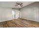 Spacious room featuring stylish wood floors, a ceiling fan, and arched doorways leading to other areas at 635 S Lanus Dr, Gilbert, AZ 85296
