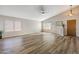 Bright living room features hardwood floors, large windows, ceiling fan and neutral paint palette at 635 S Lanus Dr, Gilbert, AZ 85296