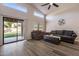 Spacious living area features wood-look floors, vaulted ceilings, and sliding glass doors to the backyard at 635 S Lanus Dr, Gilbert, AZ 85296