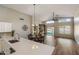 Open concept living room with vaulted ceilings, hardwood floors, and access to the backyard at 635 S Lanus Dr, Gilbert, AZ 85296