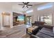Spacious living room with vaulted ceilings, a modern ceiling fan, and wood-look floors at 635 S Lanus Dr, Gilbert, AZ 85296
