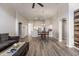 Open-concept living space with a kitchen view, wood-look floors, and natural light at 635 S Lanus Dr, Gilbert, AZ 85296