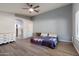 Bright main bedroom boasts wood floors, ceiling fan and ensuite access at 635 S Lanus Dr, Gilbert, AZ 85296