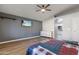 Spacious main bedroom boasting vaulted ceiling, wood floor and television at 635 S Lanus Dr, Gilbert, AZ 85296