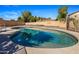 Backyard view of private pool with clear blue water and patio area surrounded by block wall at 635 S Lanus Dr, Gilbert, AZ 85296