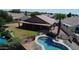 Backyard oasis featuring a private pool with an attached covered patio, ideal for relaxing, along with a grassy lawn at 635 S Lanus Dr, Gilbert, AZ 85296