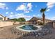 Inviting backyard pool area with rock landscaping and a privacy fence at 635 S Lanus Dr, Gilbert, AZ 85296
