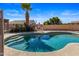 Inviting backyard pool with a tanning ledge, lounge seating, and privacy landscaping at 635 S Lanus Dr, Gilbert, AZ 85296