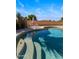 Backyard pool with a tanning ledge, lounge seating, and privacy landscaping at 635 S Lanus Dr, Gilbert, AZ 85296