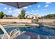 Inviting backyard pool with chairs, privacy fence, and a view of the sky at 635 S Lanus Dr, Gilbert, AZ 85296