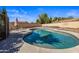 Backyard view of private pool with seating, clear blue water, and patio area surrounded by block wall at 635 S Lanus Dr, Gilbert, AZ 85296