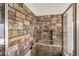 Walk-in shower featuring unique stone tile and convenient built-in shelving at 635 S Lanus Dr, Gilbert, AZ 85296