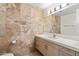 Bathroom features a quartz countertop vanity, wood cabinets, and tiled walls at 7117 E Rancho Vista Dr # 3010, Scottsdale, AZ 85251