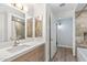 Bathroom features quartz countertops, wood cabinets, tiled walls, and a shower-tub combo at 7117 E Rancho Vista Dr # 3010, Scottsdale, AZ 85251