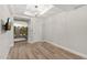 Bright bedroom with light hardwood floors, a modern ceiling fixture and a sliding door to the balcony at 7117 E Rancho Vista Dr # 3010, Scottsdale, AZ 85251