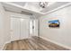Bright bedroom with light hardwood floors, a modern ceiling fixture and a closet with sliding doors at 7117 E Rancho Vista Dr # 3010, Scottsdale, AZ 85251