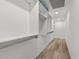 Walk-in closet with built-in shelving and wood floors at 7117 E Rancho Vista Dr # 3010, Scottsdale, AZ 85251